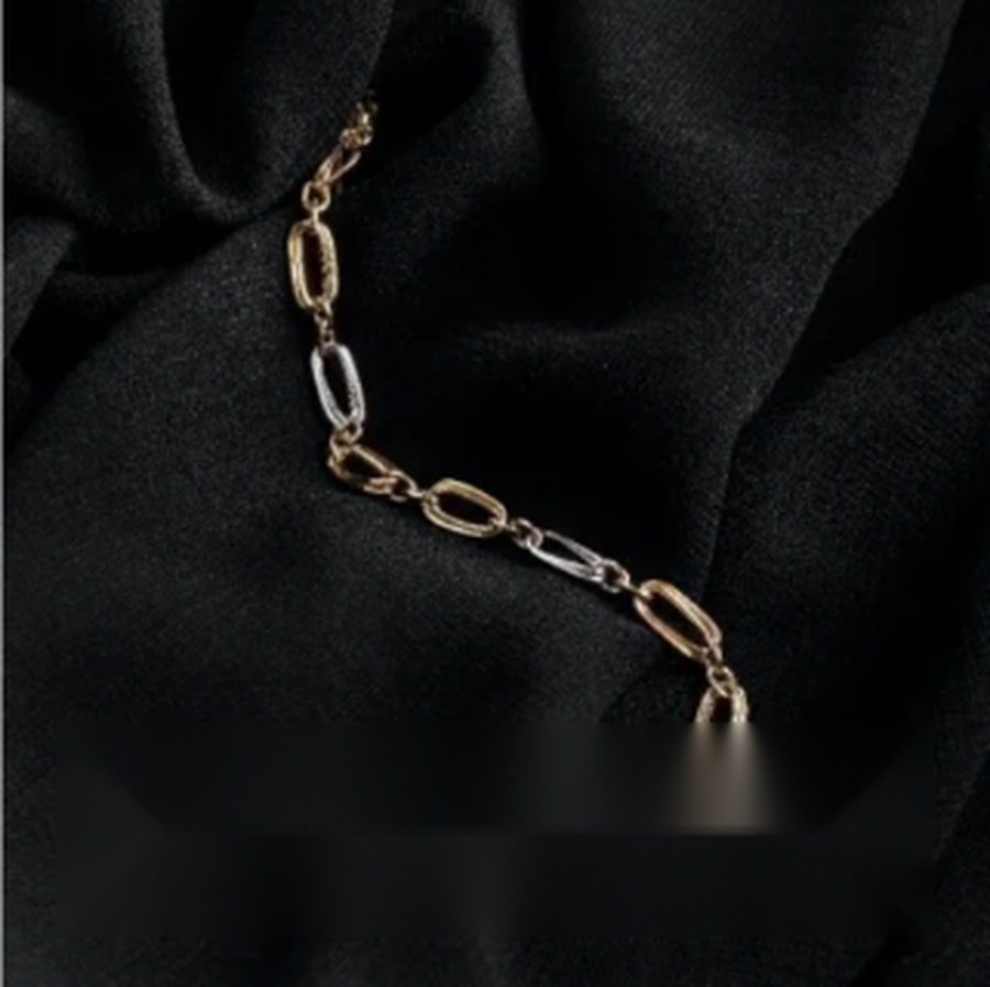 Gold and silver chain on black fabric