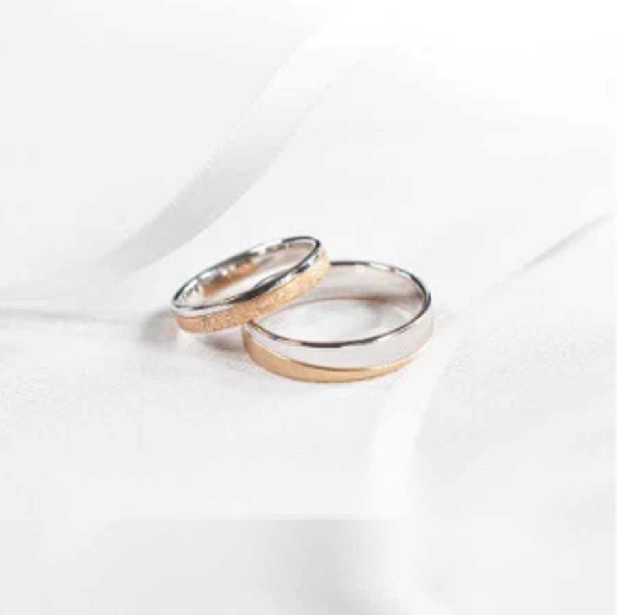 Wedding rings on white fabric